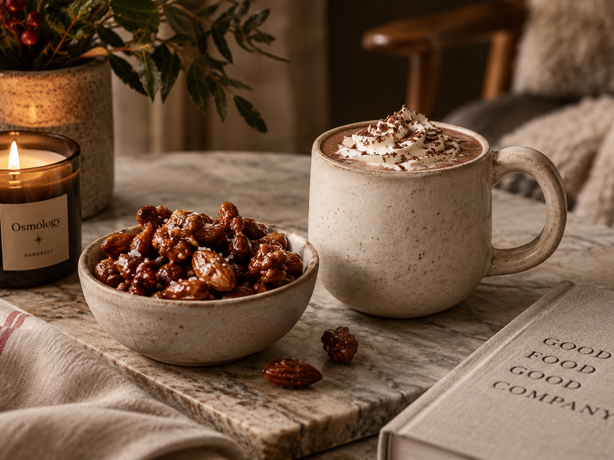 Proper Presents lifestyle scene with hot chocolate, hot honey nuts and candle